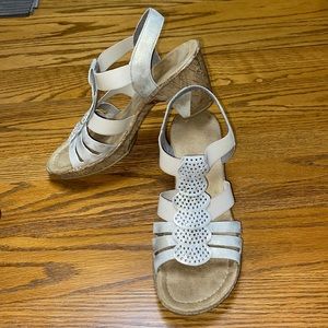 Rieker gold sandals with scalloped jewel straps.